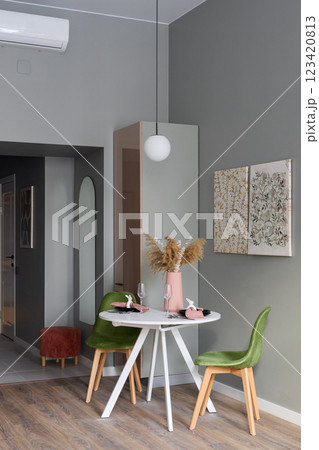 A Modern Dining Area Featuring Stylish Decor and Beautiful Green Accents That Inspire A Modern Dining Area Featuring Stylish Decor and Beautiful Green Accents That Inspire 123420813
