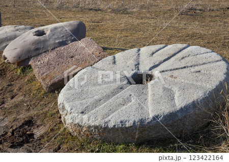 Ancient mill stone on the territory of the specially protected archaeology and architectural complex Burana Tower in Kyrgyzstan 123422164
