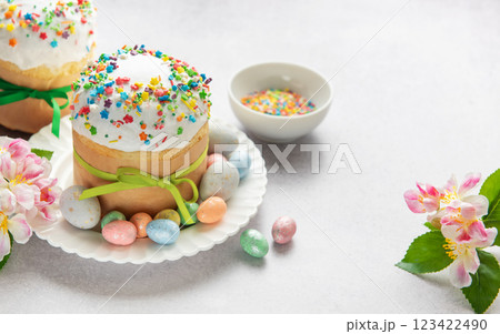 Easter cakes decorated with colorful sprinkles and chocolate eggs on festive table Easter cakes decorated with colorful sprinkles and chocolate eggs on festive table 123422490