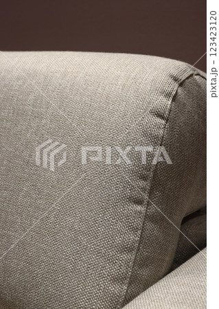 This is a Textured Upholstery Corner of a Sofa that enhances the overall ambiance and style This is a Textured Upholstery Corner of a Sofa that enhances the overall ambiance and style 123423120