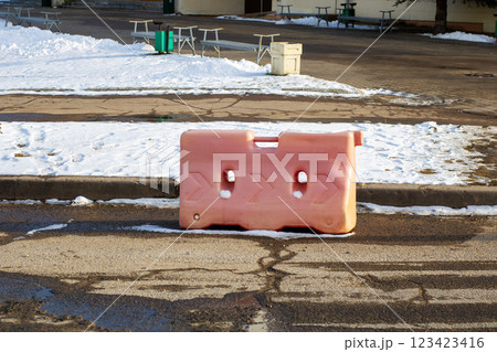 A bright pink plastic barrier is positioned on the side of a busy road 123423416