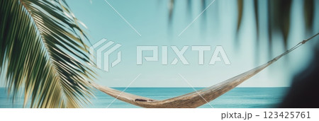 Empty hammock hanging between two palm trees on a tropical beach invites to relaxation and evokes a sense of peace and tranquility, perfect for summer vacation 123425761