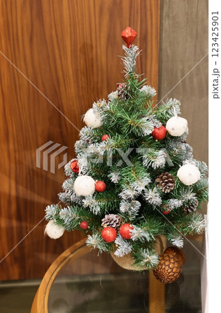 A festive Christmas decoration with enchanting snow and vibrant ornaments enhancing the ambiance A festive Christmas decoration with enchanting snow and vibrant ornaments enhancing the ambiance 123425901