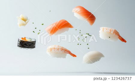 Fresh salmon nigiri, shrimp nigiri, squid nigiri, and sushi rolls with chives levitating on a minimalist white background create a dynamic culinary scene 123426737