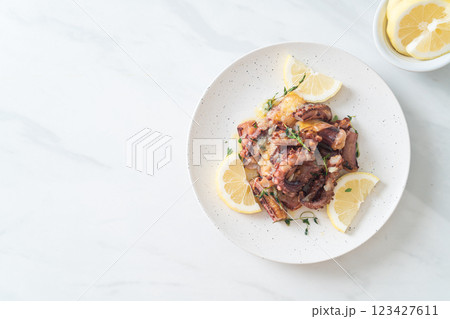 grilled octopus or squid with butter lemon sauce 123427611