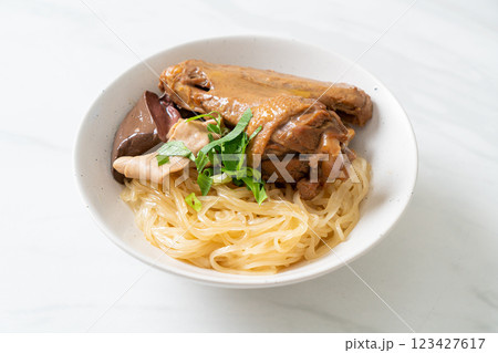 dried noodles with braised duck in white bowl dried noodles with braised duck in white bowl 123427617