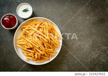 French fries with sour cream and ketchup 123427632