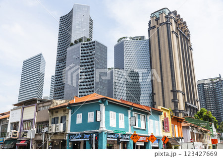 Street view of the traditional shophouses with a skyscraper background in Kampong Glam, Singapore, there are many exotic Middle Eastern restaurants, and homeware shops here. Street view of the traditional shophouses with a skyscraper background in Kampong Glam, Singapore, there are many exotic Middle Eastern restaurants, and homeware shops here. 123427669