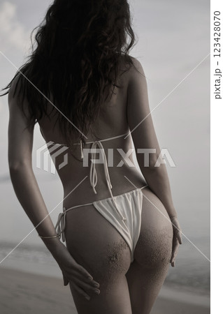Beautiful body woman on the beach. Sexy back of girl in Bikini. Monochrome silhouette 123428070