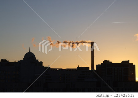 The picturesque Industrial Skyline at Sunset showcasing Emission Smoke and its beauty The picturesque Industrial Skyline at Sunset showcasing Emission Smoke and its beauty 123428515