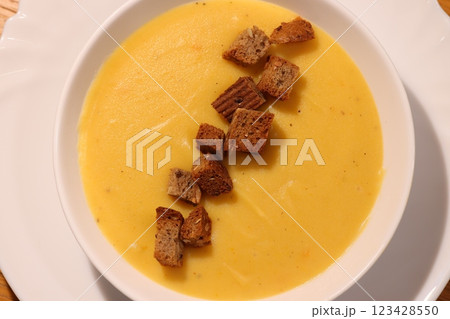 Indulge in a bowl of Creamy Pumpkin Soup garnished with crunchy Croutons, deliciously made Indulge in a bowl of Creamy Pumpkin Soup garnished with crunchy Croutons, deliciously made 123428550