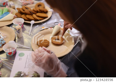 Engaging in the Fun of Decorating Cookies at a Joyful and Festive Community Event 123428556