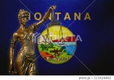 Lady Justice before a flag of Montana 123428802