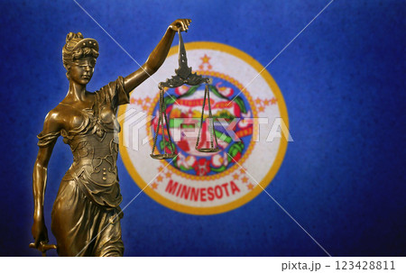 Lady Justice before a flag of Minnesota Lady Justice before a flag of Minnesota 123428811