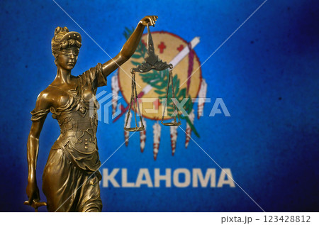 Lady Justice before a flag of Oklahoma 123428812