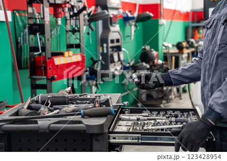 Serviceman repair car in car service 123428954