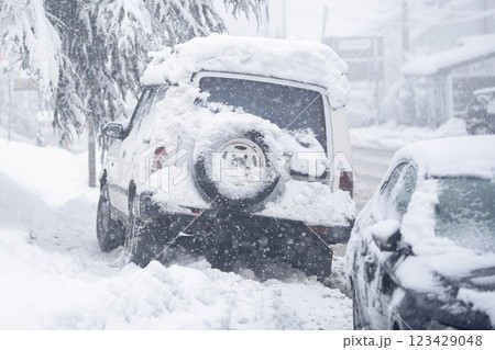 Parked car covered with snow during snow storm 123429048