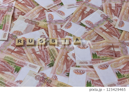 Background of five thousand Russian ruble banknotes with inscription RUSSIA on wooden blocks, currency exchange, accumulation of cash, banking system Background of five thousand Russian ruble banknotes with inscription RUSSIA on wooden blocks, currency exchange, accumulation of cash, banking system 123429465
