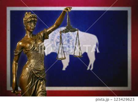 Lady Justice before a flag of Wyoming 123429623