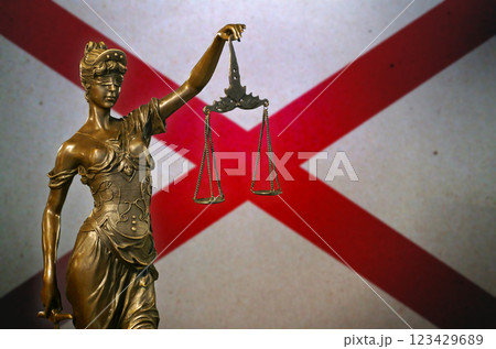 Lady Justice before a flag of Alabama Lady Justice before a flag of Alabama 123429689