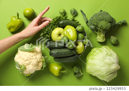 Set of protein vegetables and hand on green background, top view Set of protein vegetables and hand on green background, top view 123429953