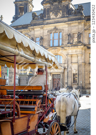 Horse drawn carriage, popular form of sightseeing for tourists visiting historic Old town district of Dresden, Saxony, Germany Horse drawn carriage, popular form of sightseeing for tourists visiting historic Old town district of Dresden, Saxony, Germany 123430422
