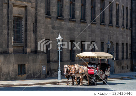 Horse drawn carriage, popular form of sightseeing for tourists visiting historic Old town district of Dresden, Saxony, Germany Horse drawn carriage, popular form of sightseeing for tourists visiting historic Old town district of Dresden, Saxony, Germany 123430446