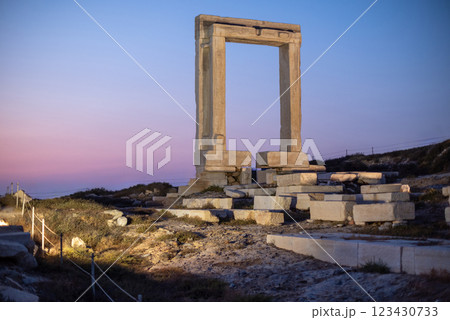 People watch sunset at Portara gate of the Temple of Apollo at Naxos island in the Cyclades, Aegean Sea, Greece People watch sunset at Portara gate of the Temple of Apollo at Naxos island in the Cyclades, Aegean Sea, Greece 123430733