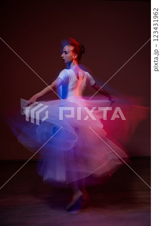 Caucasian woman dancing classical dance in tutu . Long exposure photo. Caucasian woman dancing classical dance in tutu . Long exposure photo. 123431962