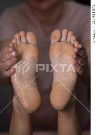 Close-up of a woman's feet massage. Vertical photo. 123431973