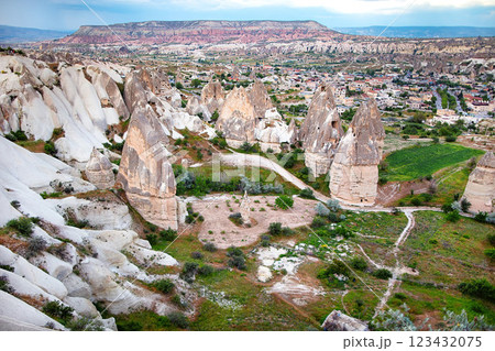 Majestic rock formations rise above the enchanting landscape of Cappadocia at sunset. 123432075