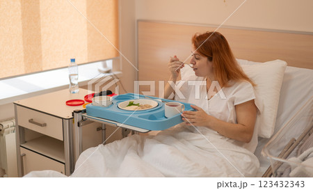 Caucasian woman eating on hospital bed. Caucasian woman eating on hospital bed. 123432343