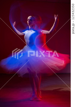 Caucasian woman dancing classical dance in tutu . Long exposure photo. Caucasian woman dancing classical dance in tutu . Long exposure photo. 123432350