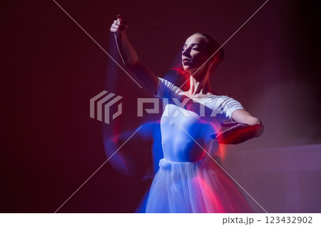 Caucasian woman dancing classical dance in tutu . Long exposure photo.  123432902