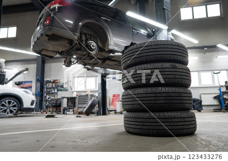 Changing tires for a car according to the season.  123433276