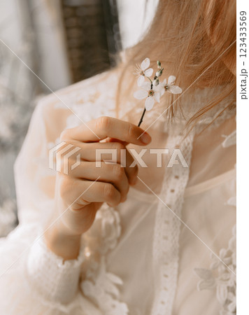 Woman holding a branch with flowers. Spring beauty concept 123433569