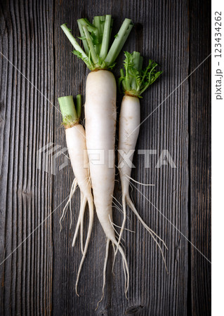 Top view of white daikon radish with roots 123434262