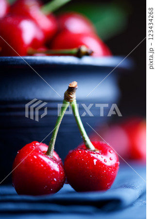 Macro shot of two red cherries with water drops 123434268