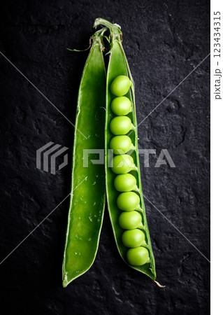 Green sugar snap pea pod with kernels in a row 123434315