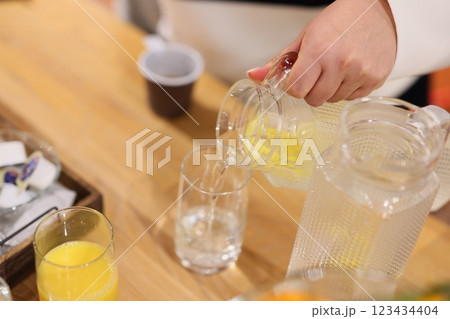 Preparing a refreshing beverage that features a delightful citrus infusion for enjoyment Preparing a refreshing beverage that features a delightful citrus infusion for enjoyment 123434404