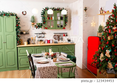 Christmas table with white tablecloth New Year tree green furniture. New Year's kitchen photo zone 123434453