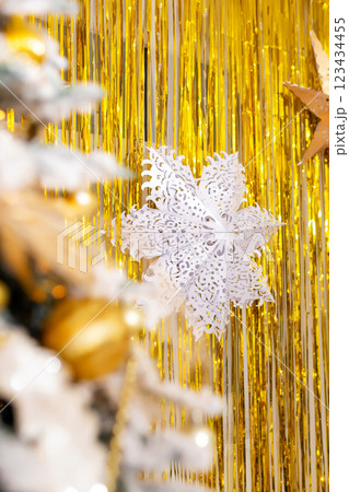 paper stars on a background of golden rain. fake snowflakes on a background of golden ribbons paper stars on a background of golden rain. fake snowflakes on a background of golden ribbons 123434455