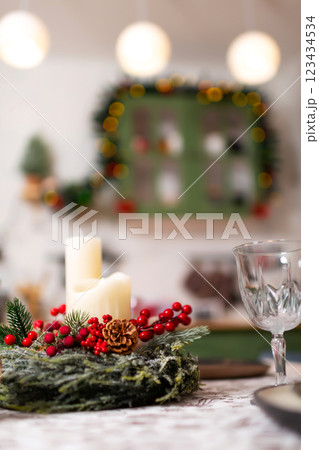 New Year's table setting in a photo studio. Plates with glasses on a Christmas tablecloth 123434534