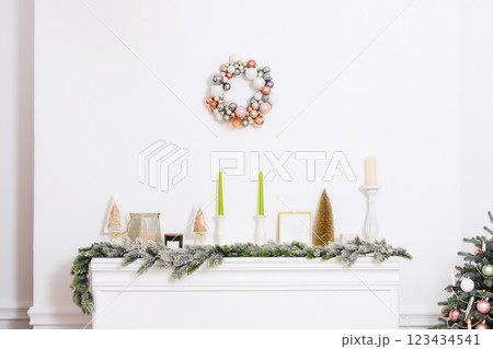 white fireplace with home christmas decor on top. new year fake fireplace in photo studio 123434541
