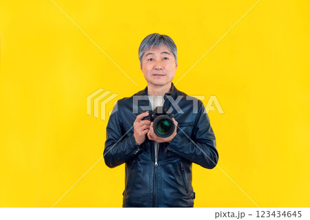 黄色背景カメラを持つ男性 123434645