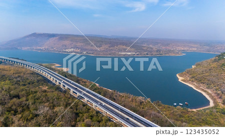 Drone shot aerial view landscape of the M6 motorway Expressway Nakhon Ratchasima Province - Bang Pa-in. Lam Ta Khong River and Mountain. Drone shot of scenic landscape rural place traffic. Nakhon Drone shot aerial view landscape of the M6 motorway Expressway Nakhon Ratchasima Province - Bang Pa-in. Lam Ta Khong River and Mountain. Drone shot of scenic landscape rural place traffic. Nakhon 123435052