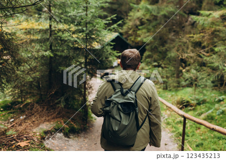 Young 30s man hiking in nature. Travel, adventure. Concept of an active lifestyle. High quality photo. Back view. Fall autumn hiker man outdoor at nature forest Young 30s man hiking in nature. Travel, adventure. Concept of an active lifestyle. High quality photo. Back view. Fall autumn hiker man outdoor at nature forest 123435213