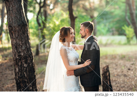 walk of the bride and groom through the autumn forest 123435540