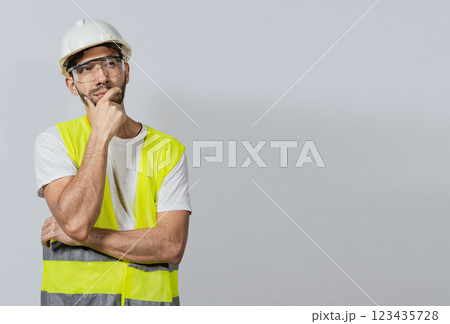 Pensive builder man with hand on chin, Portrait of young builder thinking with hand on chin isolated, A pensive engineer on white background. Concept of a meditative engineer solated Pensive builder man with hand on chin, Portrait of young builder thinking with hand on chin isolated, A pensive engineer on white background. Concept of a meditative engineer solated 123435728