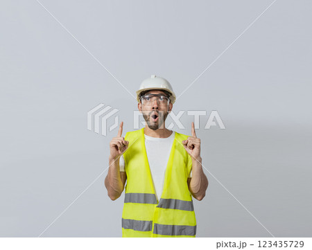 Surprised young architect pointing up, Amazed engineer pointing at an advertisement. Concept of an engineer with astonished face pointing at blank space, Amazed engineer man pointing up Surprised young architect pointing up, Amazed engineer pointing at an advertisement. Concept of an engineer with astonished face pointing at blank space, Amazed engineer man pointing up 123435729